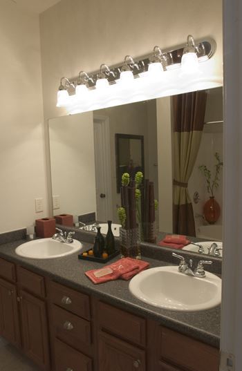 a bathroom with two sinks and a large mirror
